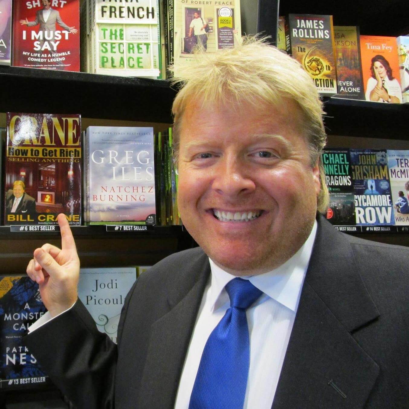Author Bill Crane Pointing to his Bestselling Book Generating Clients For Life on the shelf at Hudson Booksellers LAX, Los Angeles International Airport