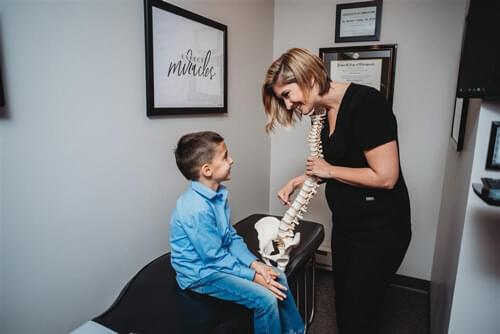 Park Ridge Chiropractor explains to a child how chiropractic care can help in our health